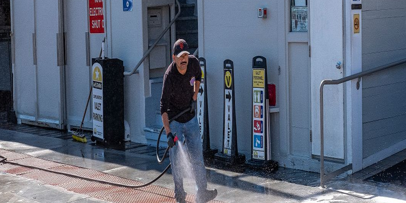 Pressure washing a sidewalk with a clean and dirty split